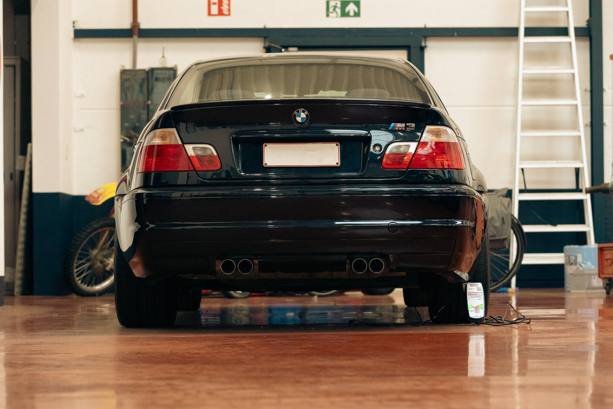 OptiMate battery charger maintaining a supercar or race car in a performance garage