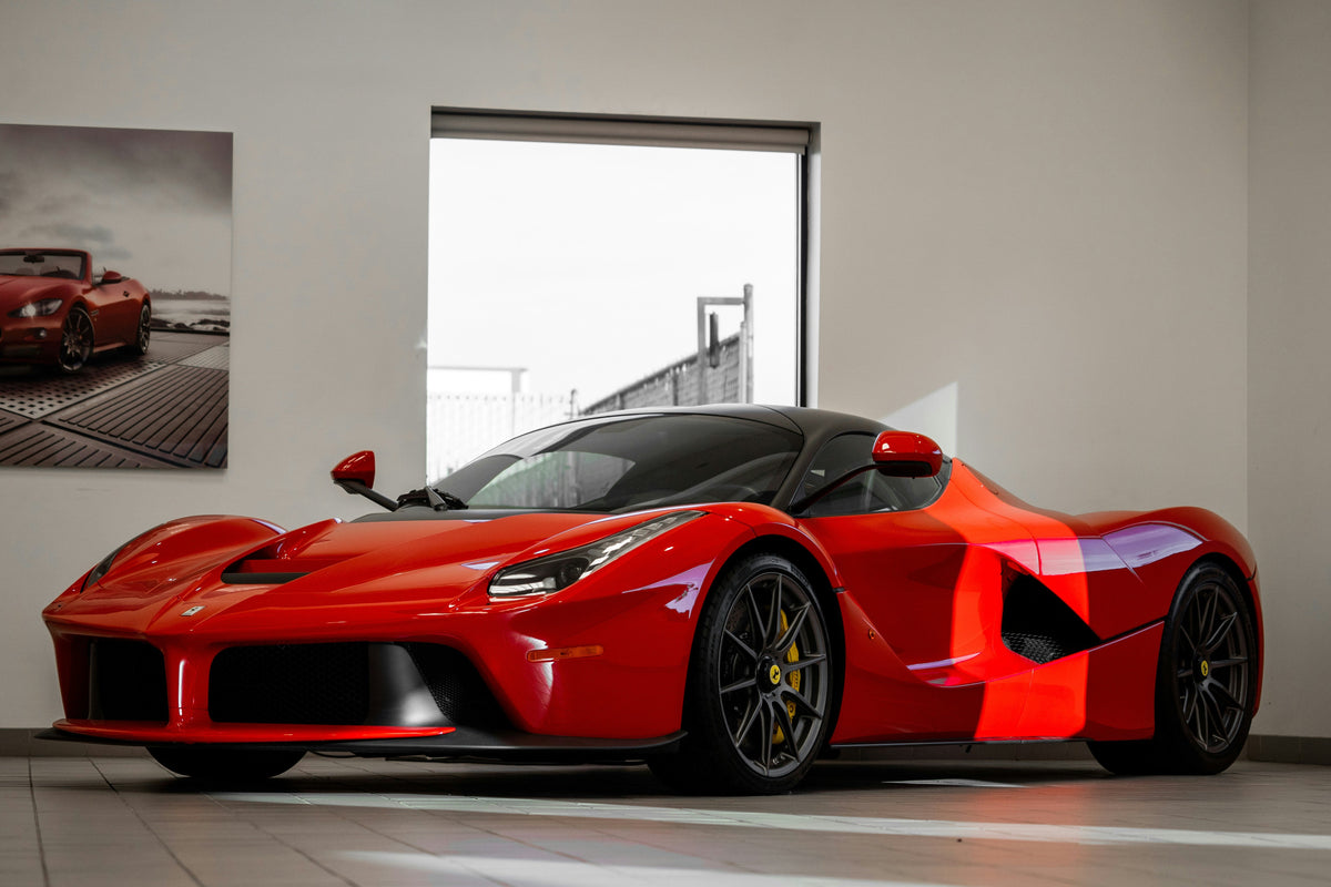 OptiMate battery charger maintaining a supercar or race car in a performance garage