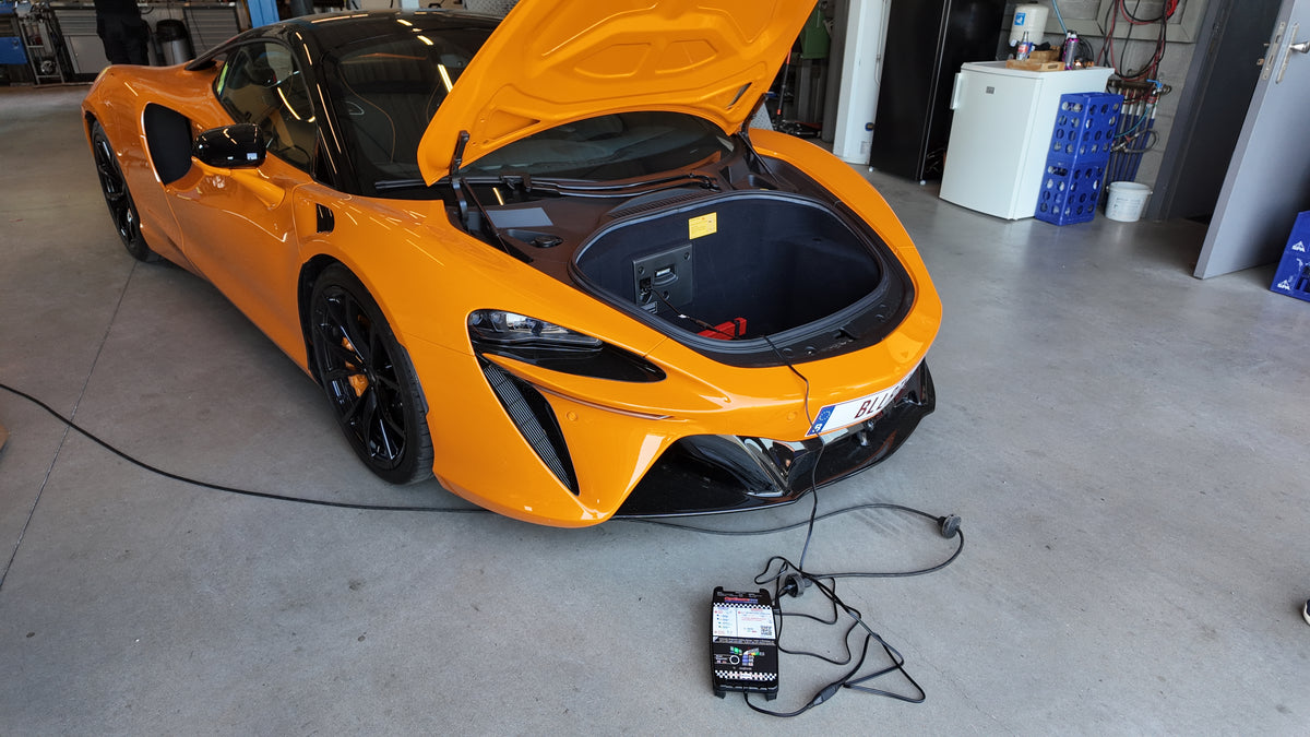 OptiMate battery charger maintaining a supercar or race car in a performance garage